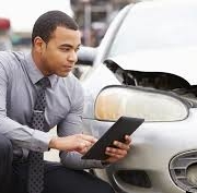 Las Vegas car accident attorney appraises vehicle damage.