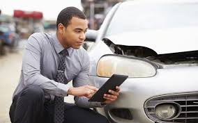 Las Vegas car accident attorney appraises vehicle damage.