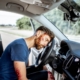 Bodily injury resulting from car accident.. Bloodied man unconscious in drivers seat with with head resting on steering wheel.