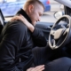 Man holding his shoulder in pain as he suffers from symptoms of whiplash after a car accident in Las Vegas